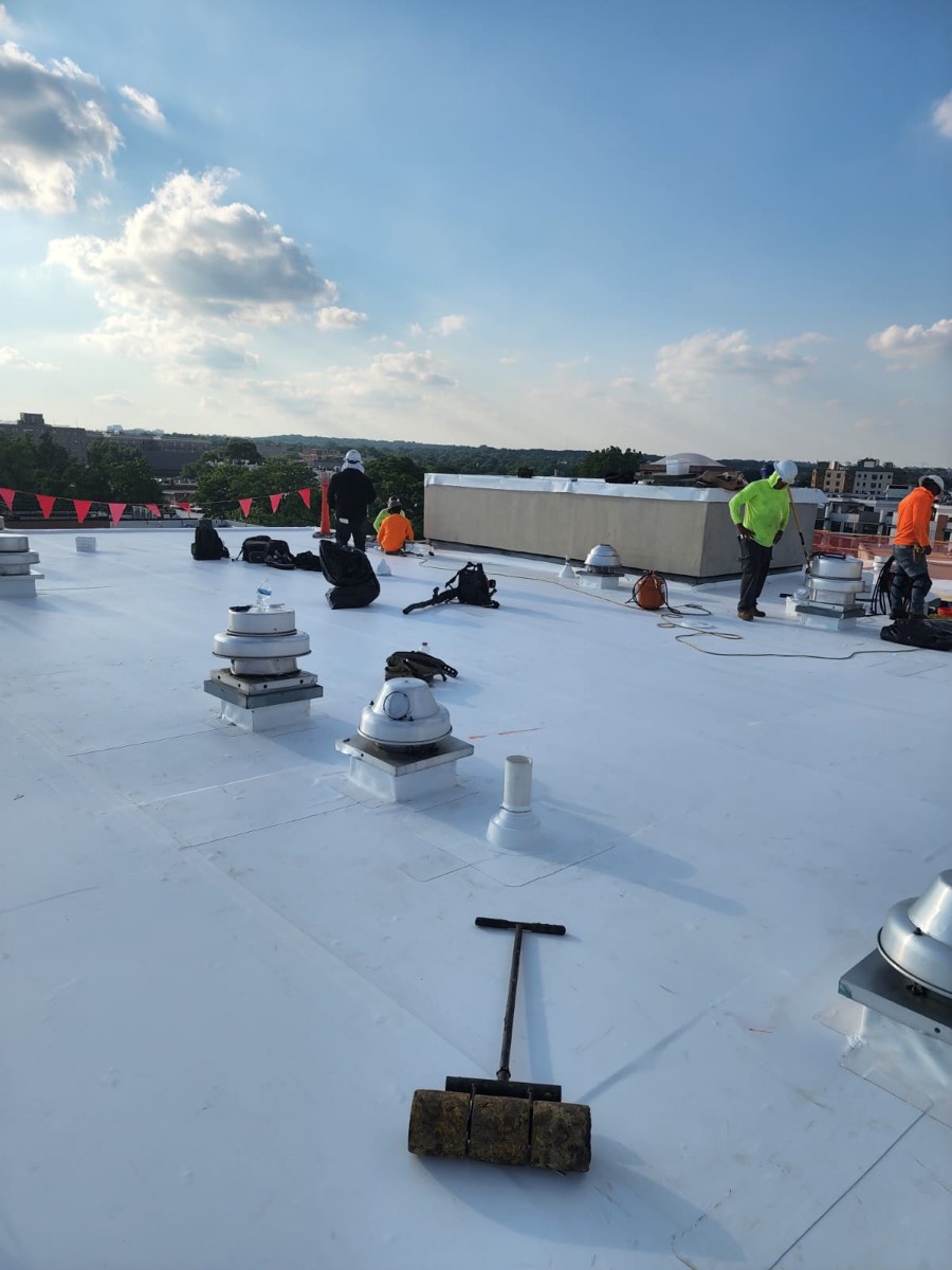 Finished white TPO roof with vents and mechanical penetrations flashed in