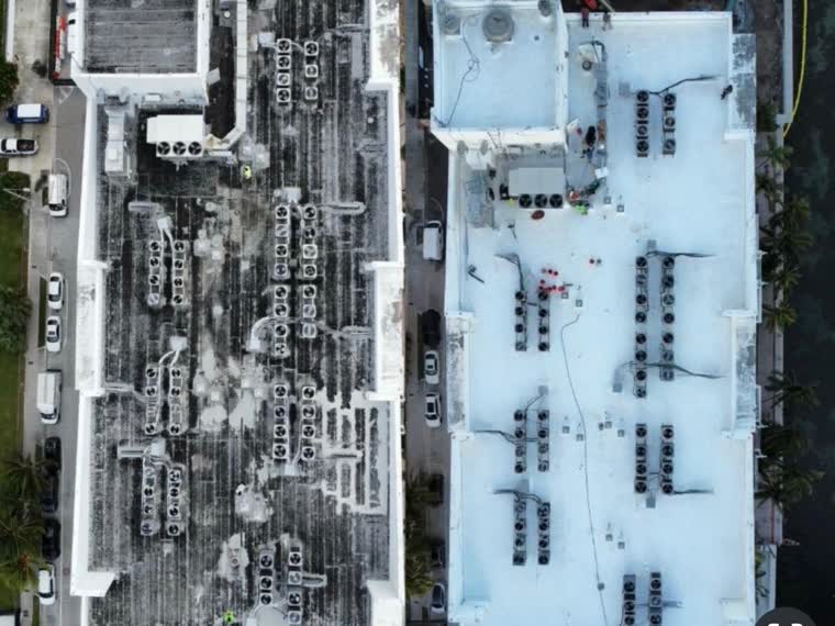 Aerial over a roof carrying a dense array of rooftop mechanical equipment.