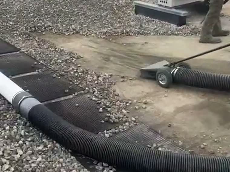 Vacuuming gravel ballast during tear-off.