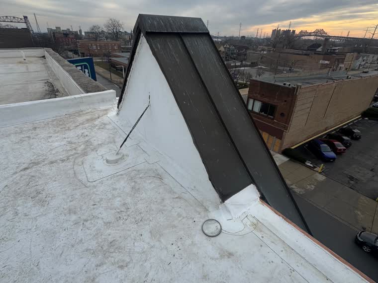 Snow on a mansard and low-slope transition — the detail that leaks first in a mid-Atlantic winter.