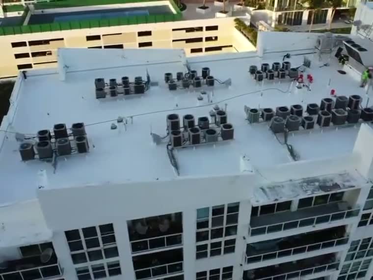 Pass over a mid-rise roof carrying a dense array of rooftop mechanical.