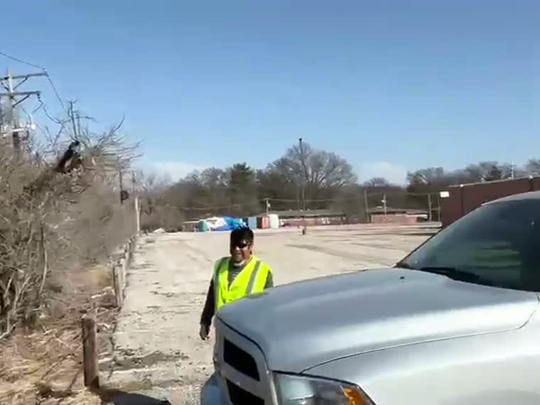 Ground-level site walk — crew and truck staged at the building.