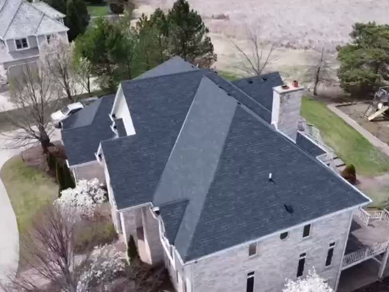 Aerial over a large pitched slate roof.