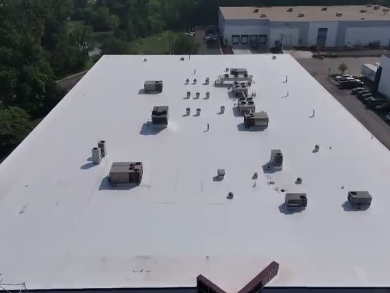 Completed reflective roof with mechanical units across the field.