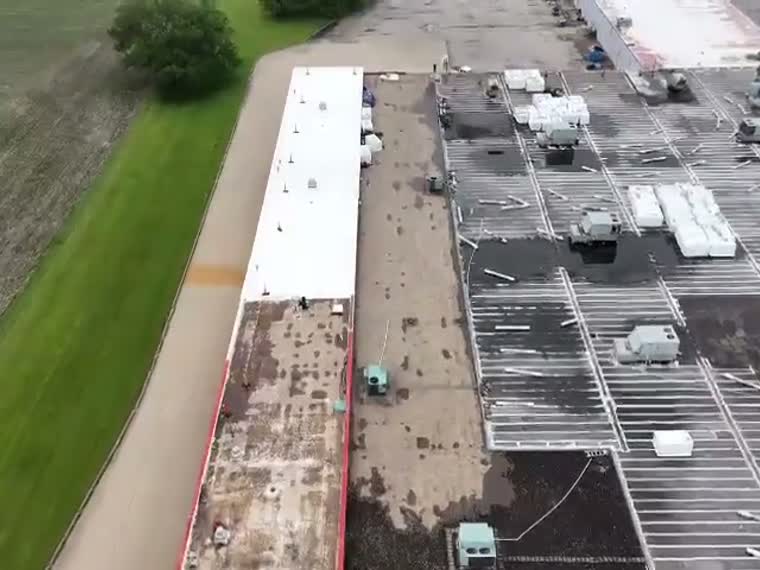 Long roof mid-project with tear-off underway.