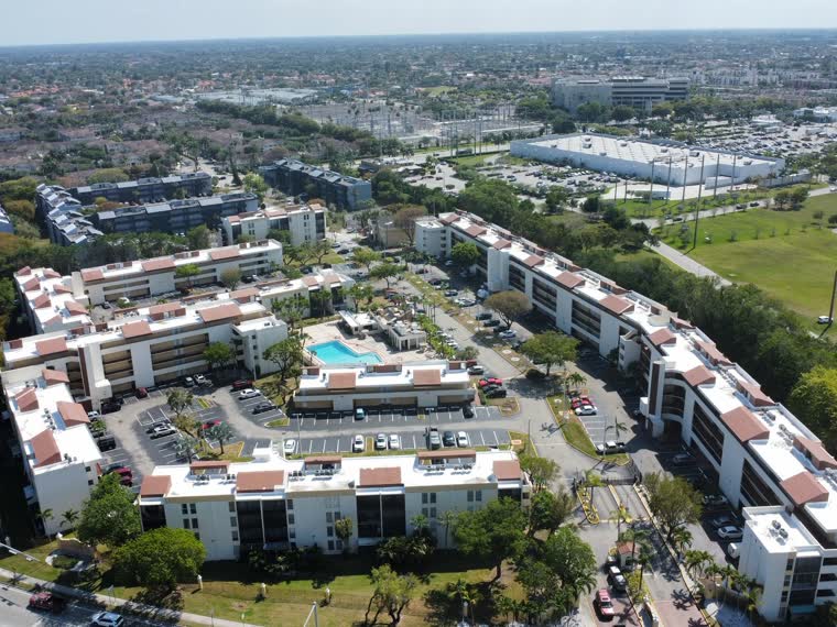 The same community from the south, showing the full roof inventory in one frame.