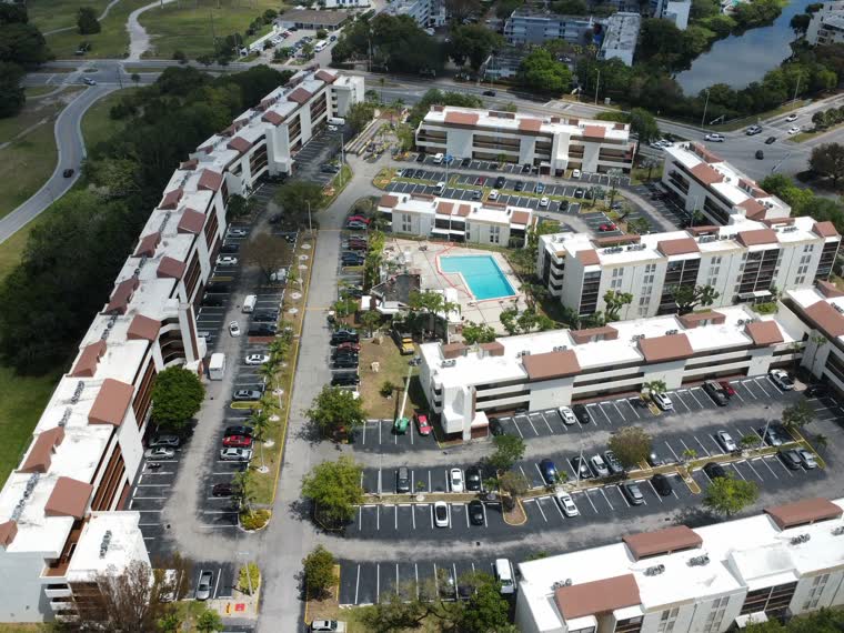 Roof field and pool deck in one frame; access routes visible between buildings.