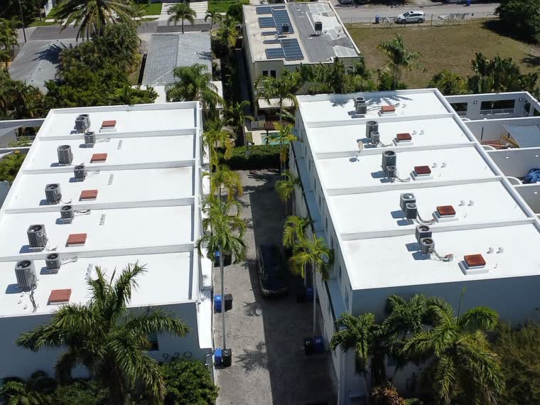 Reflective roofs stepping across a low-rise complex.