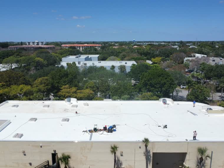 Large reflective roof over a single-storey commercial building.