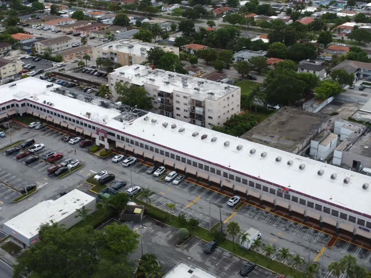 Retail centre roof with equipment arrays and screening.