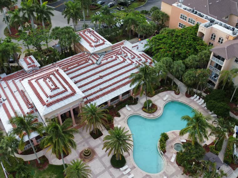Resort property — tile and low-slope sections around a pool deck.