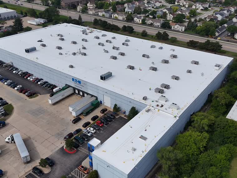 Big-box roof with heavy mechanical load, viewed along the ridge.