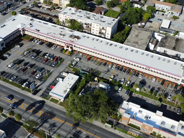 Completed roofs along a dense commercial block.