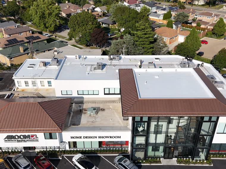 Mixed-use block with completed roofs above ground-floor retail.