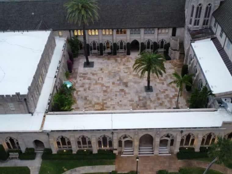 Courtyard property with arcaded elevations and completed surrounding roofs.
