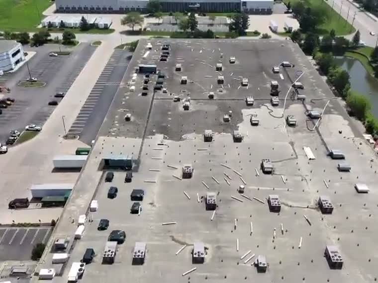 Flyover of a big-box retail roof and its parking field.