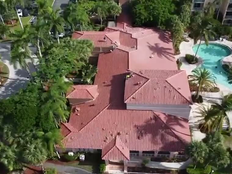 Resort property — tile roofs wrapping a pool deck.